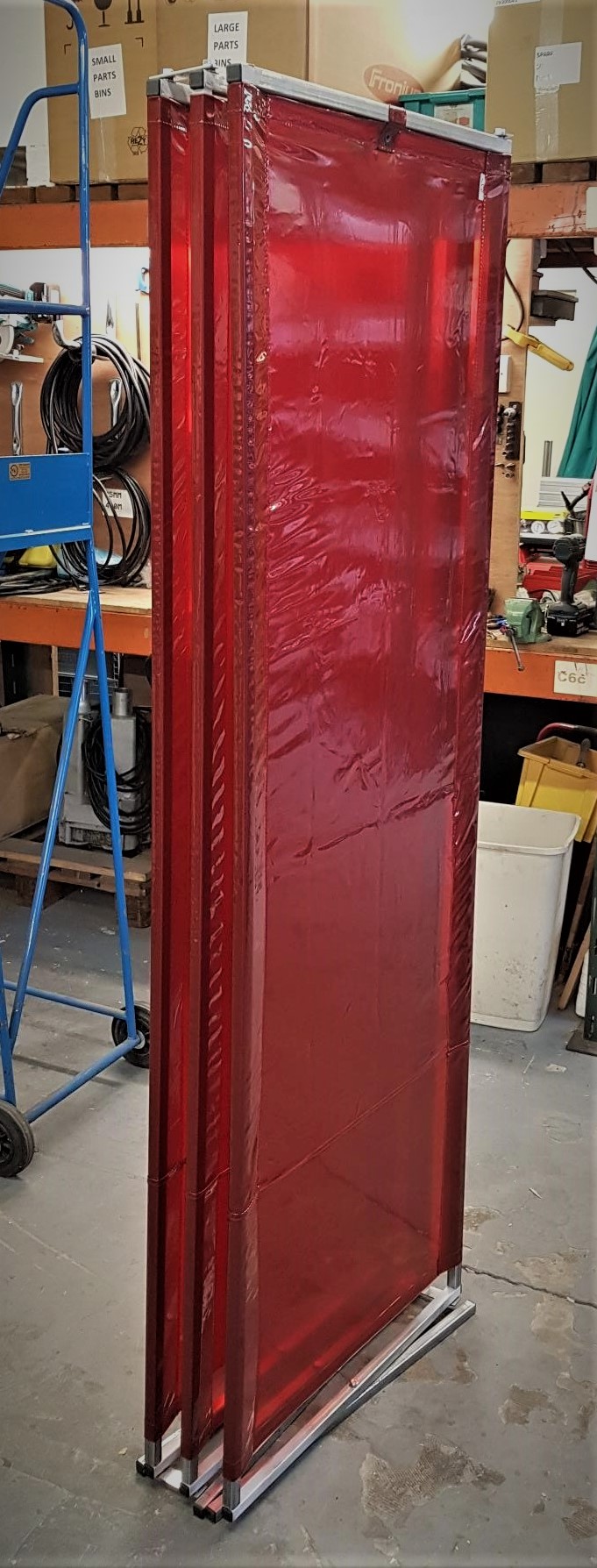 folded up red welding curtain