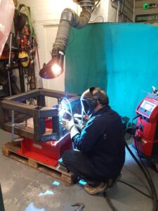 Man Using Welding Rotator in Workshop
